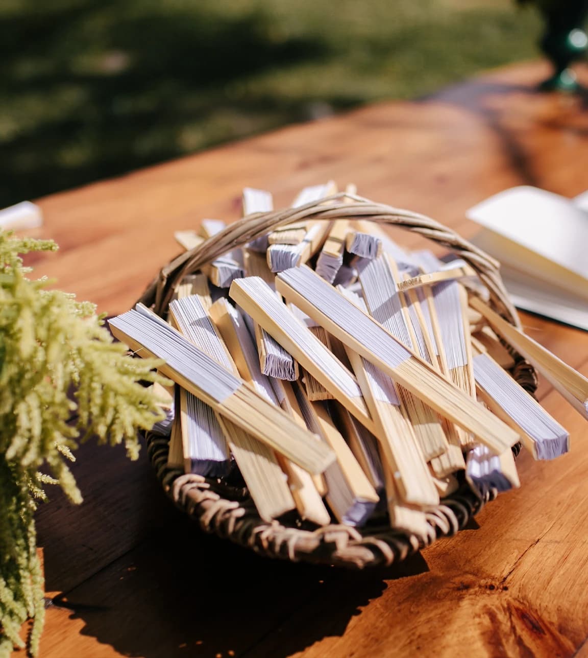Wedding favours, a bottle of digestif and custom match box, are placed on a wedding table