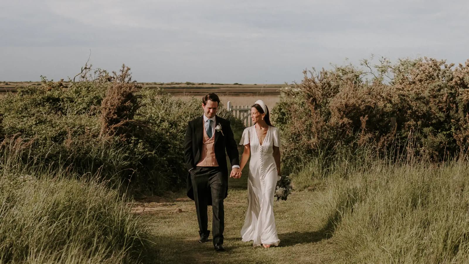 bride and groom walking in their beautiful wedding venue