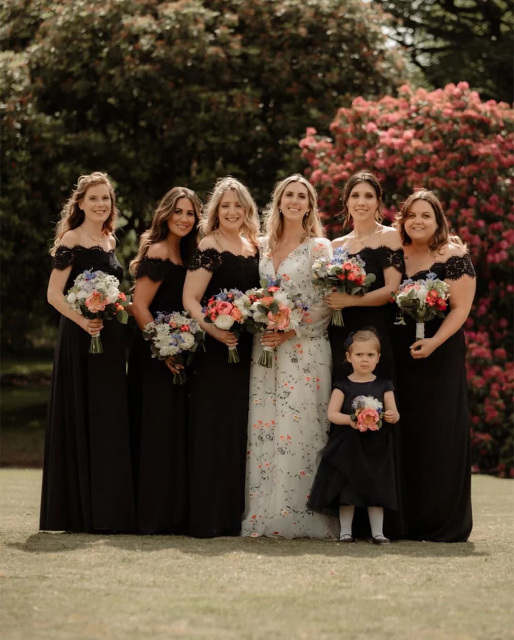 Bride and her bridesmaids who are wearing Navy Monsoon dresses