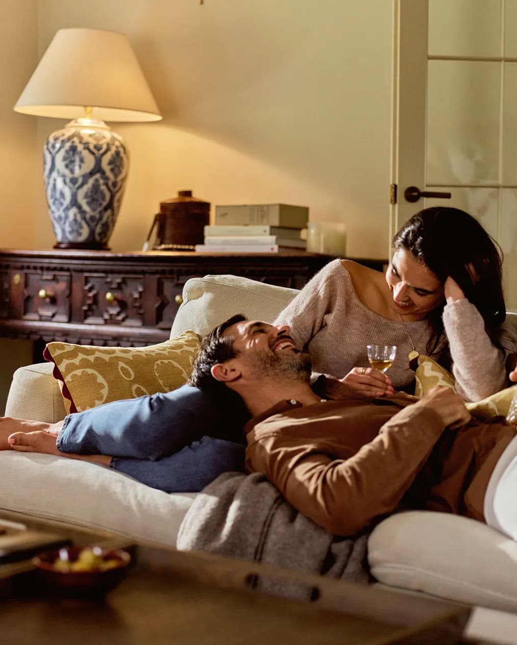 Couple in a living room with luxury homeware wedding gifts from The Wedding Present Company
