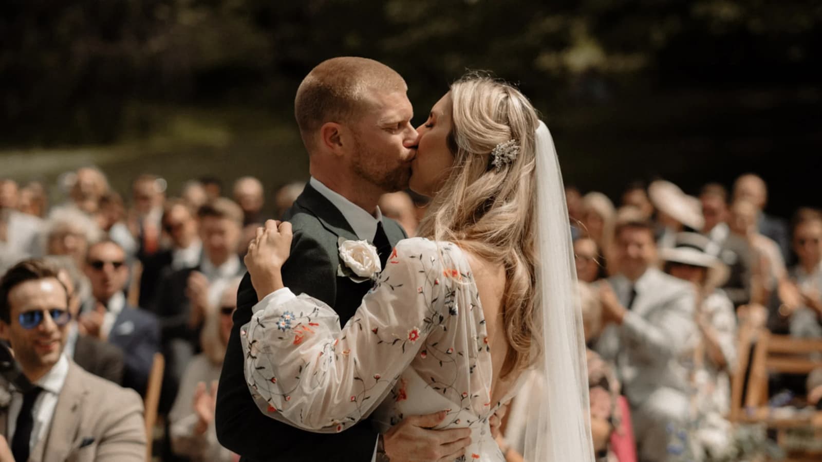 You may kiss the bride moment at this festival-themed Cornwall wedding