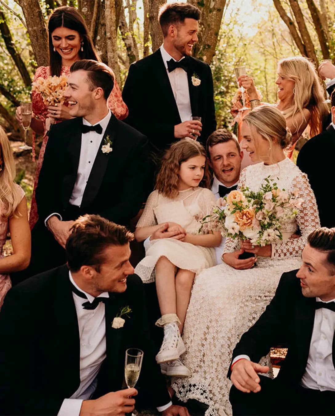 Wedding guests celebrate groom and bride with champagne 