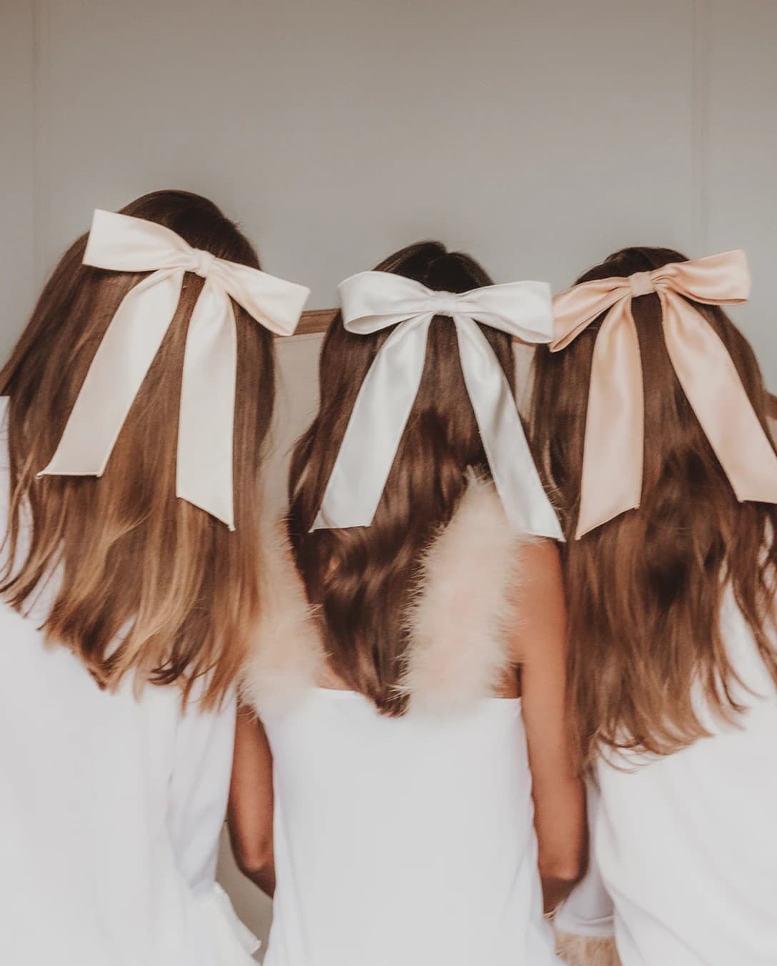 A bridal party with matching light pink hair bows from Gigi and Olive brand