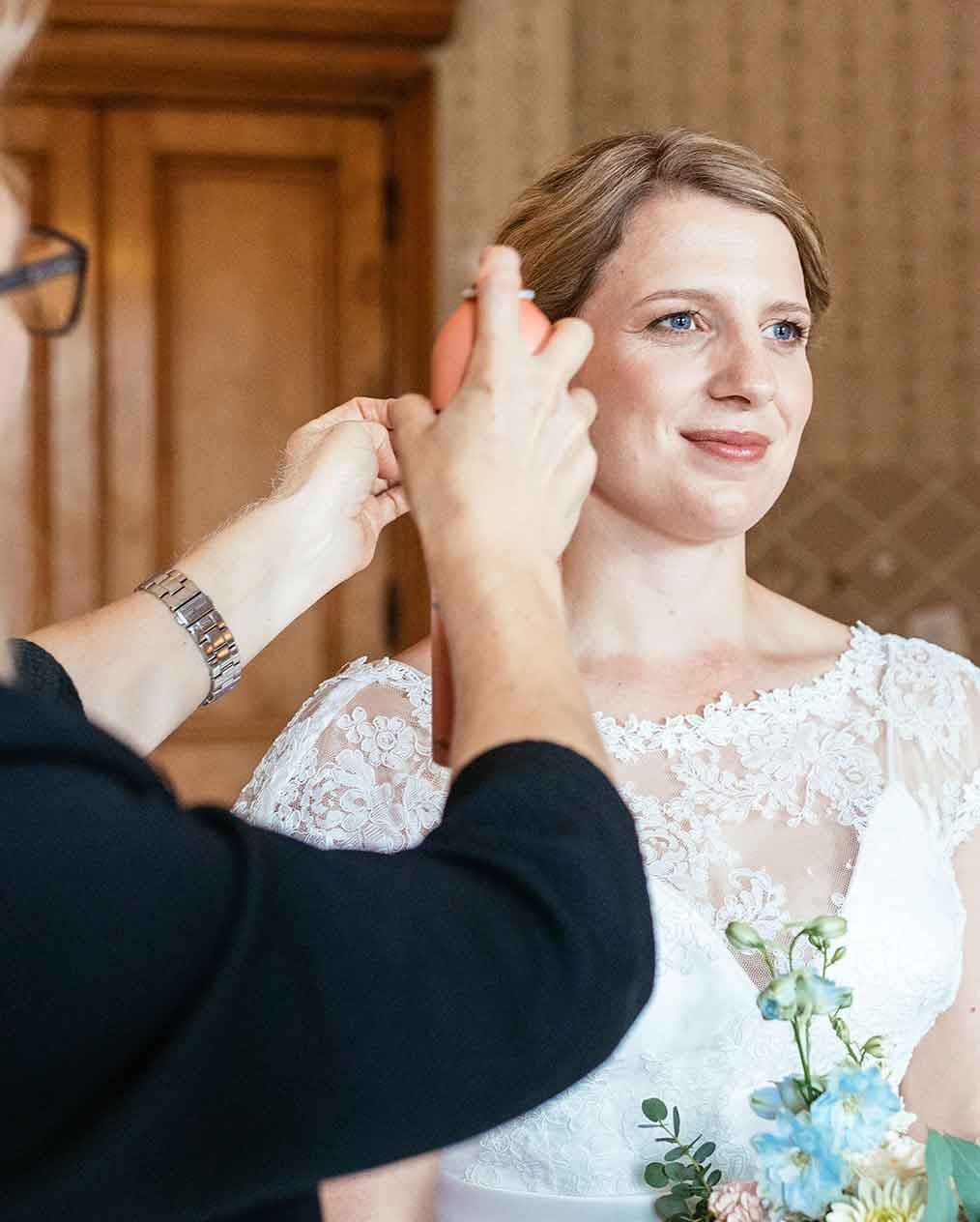 Wedding hair being done by hairdresser on bride on wedding day