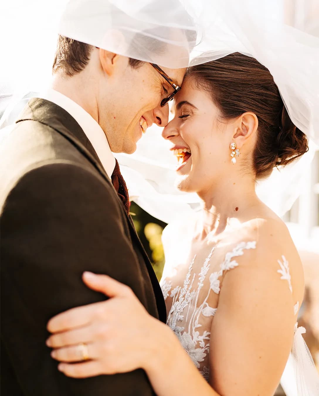 Happy bride and groom are captured in joyous moment, holding each other close
