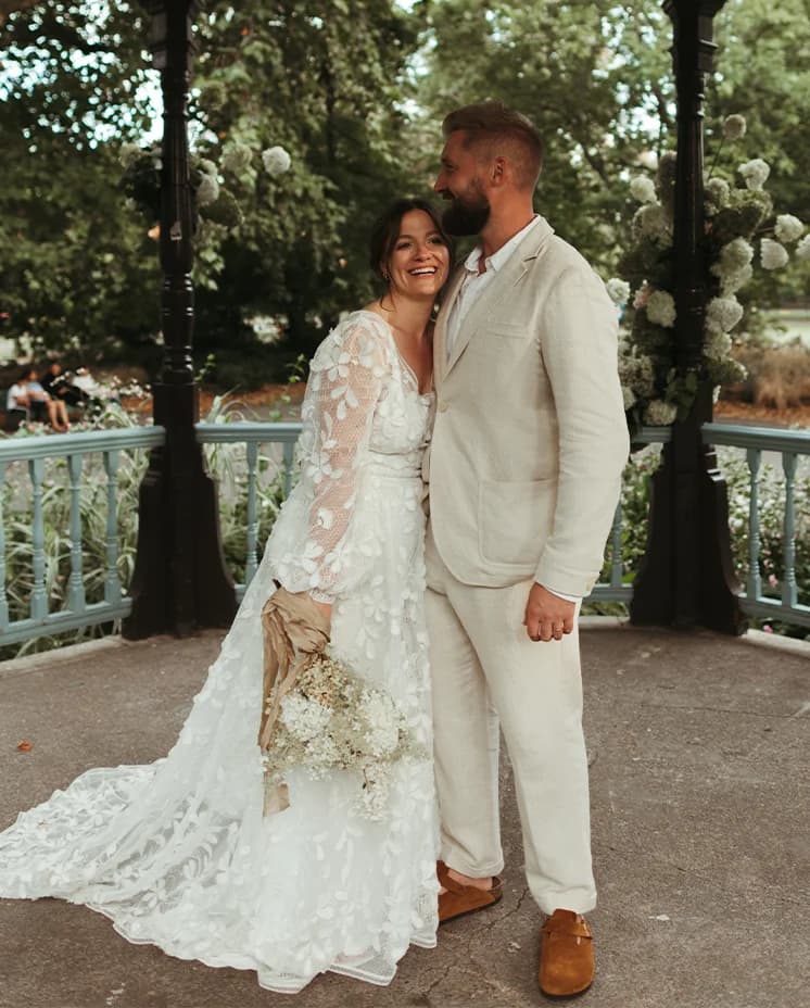 Bride and groom share a tender moment in their London park wedding venue