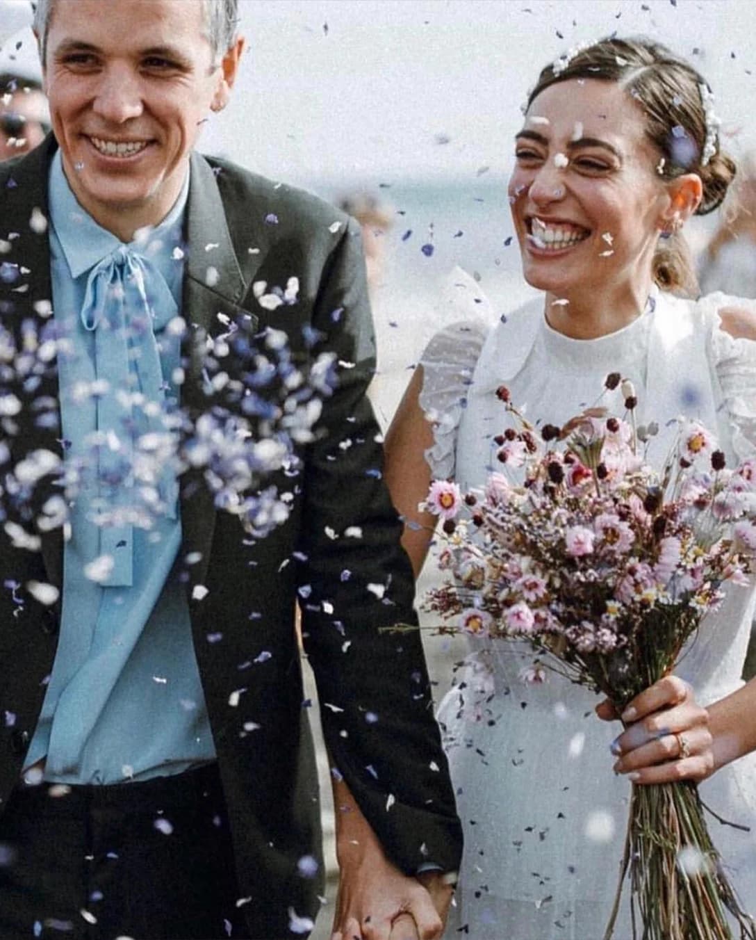 Laura Jackson and her husband Jon in the midst of wedding confetti