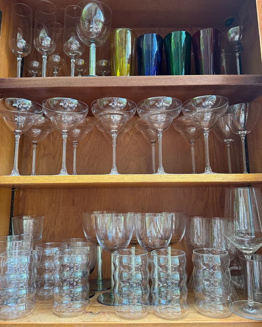 Laura Jackson's kitchen cupboard featuring her collection of glassware