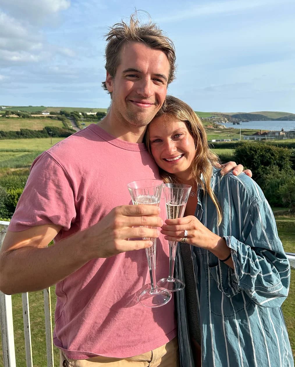 Honour Wainwright and Charlie Coleman celebrate their engagement with champagne