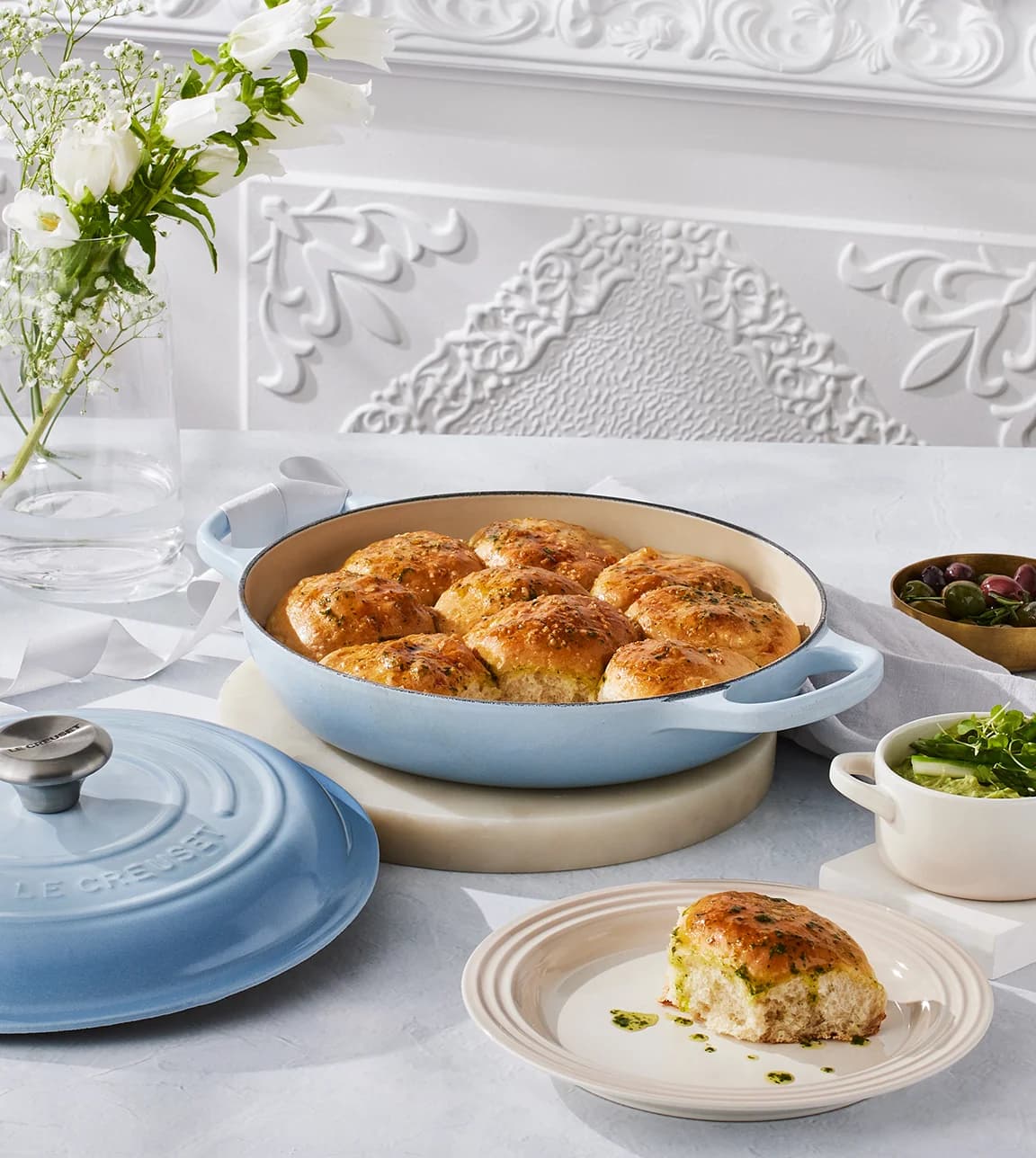 Le Creuset recipe for April featuring pull-apart dinner role served in Le Creuset shallow casserole