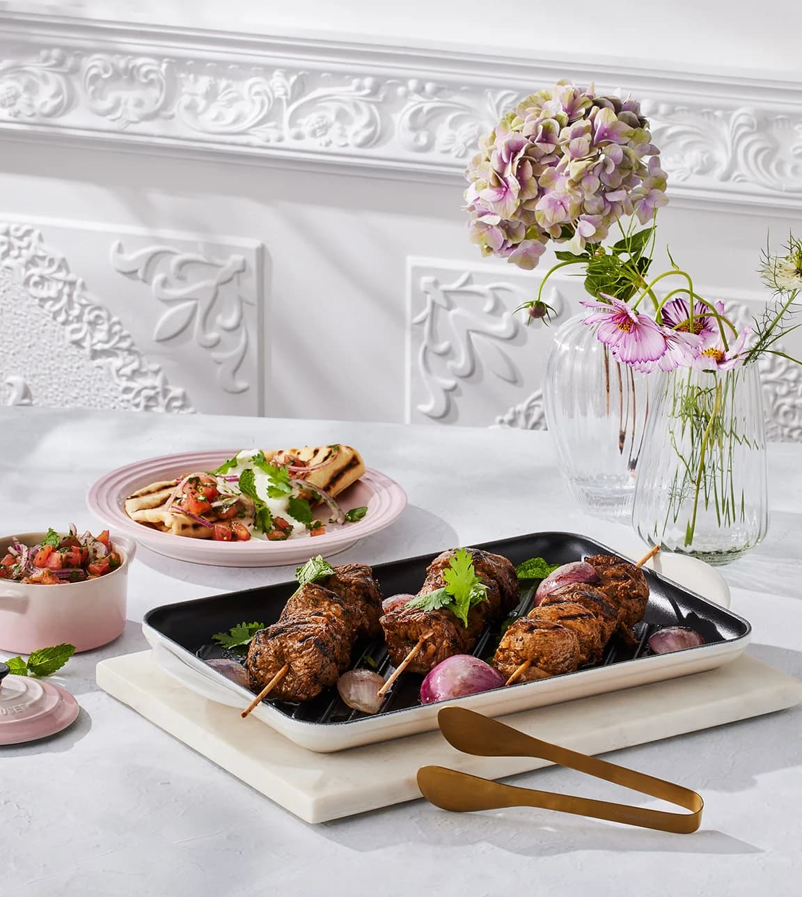 Le Creuset recipes for July featuring greek lamb skewers with flatbreads with tomato salsa on Le Creuset grill