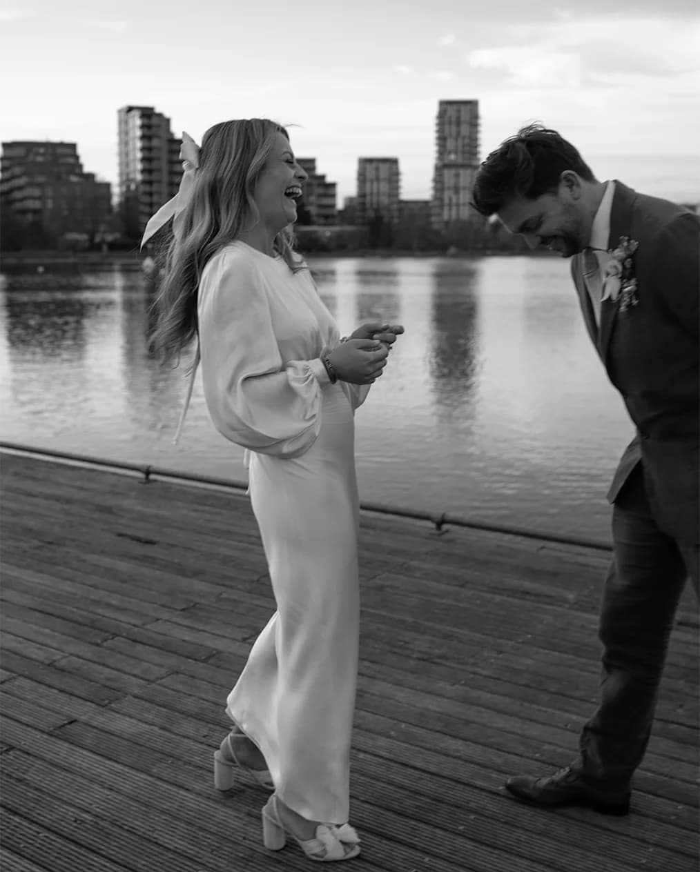 Newlyweds enjoying each other outside their wedding reception venue, West Reservoir London.