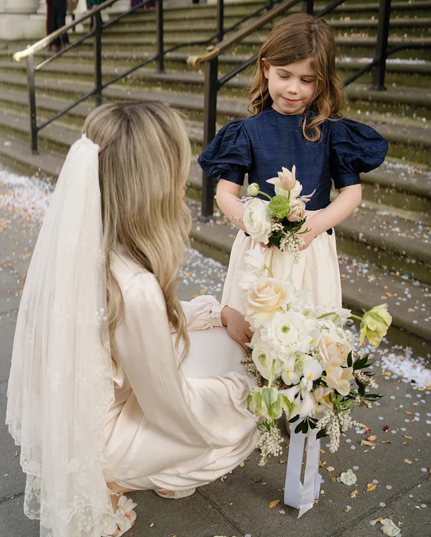 Bride with the flower girl wearing a vintage flower girl dress