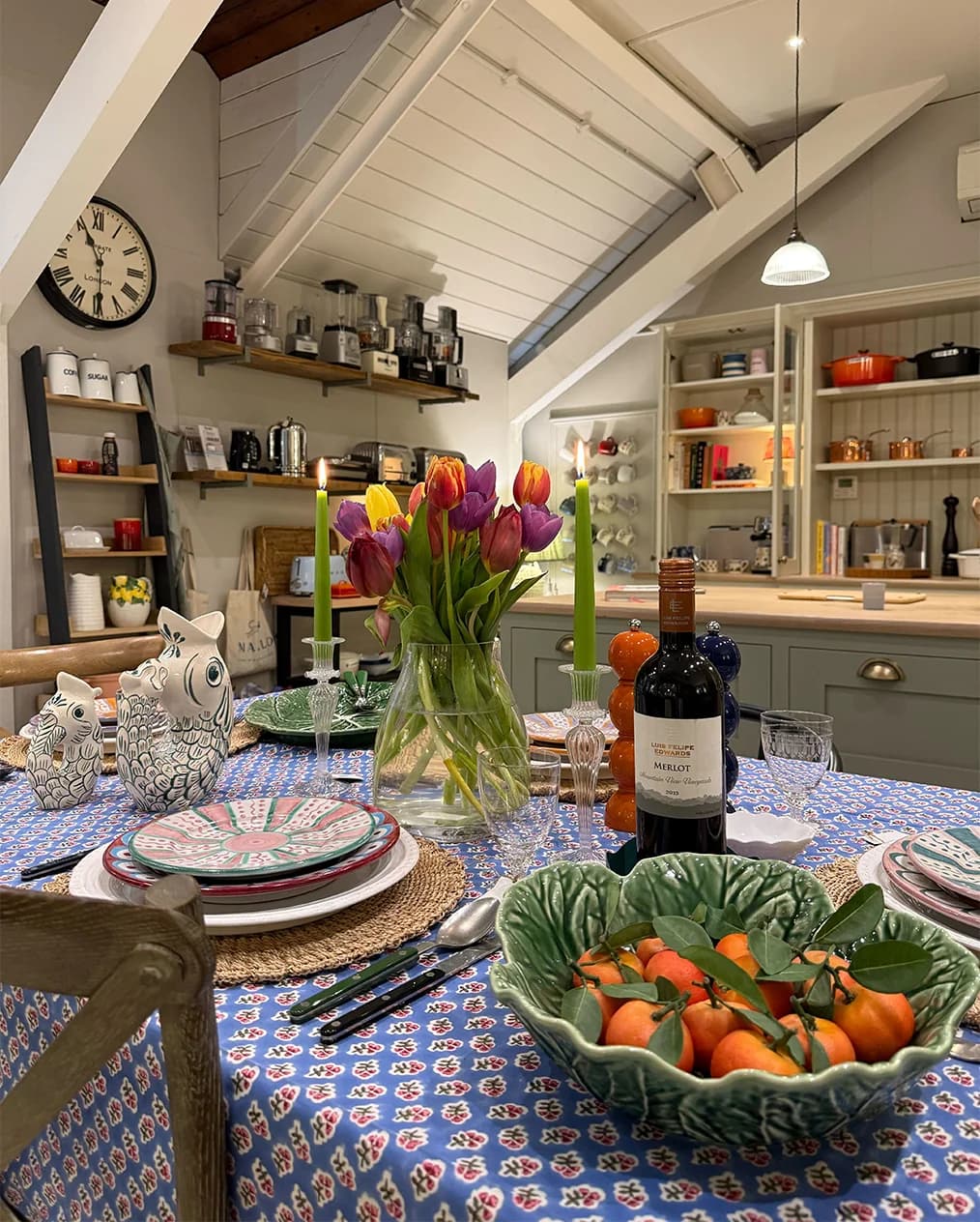 Statement table setting at The Wedding Present Company showroom, featuring printed tablecloth, unique Villa Bologna jugs, spring flowers and plates from Penny Morrison