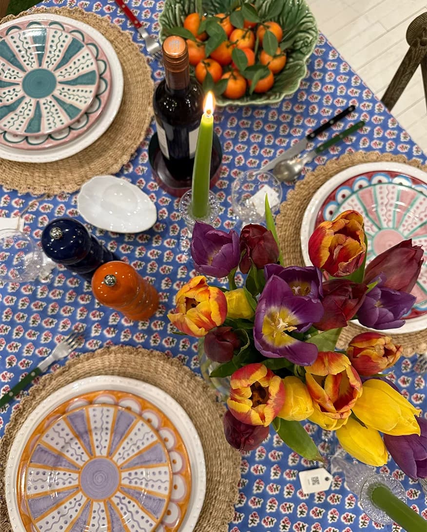 A bird view of the statement table setting at The Wedding Present Company showroom, featuring printed tablecloth, unique Villa Bologna jugs, spring flowers and plates from Penny Morrison