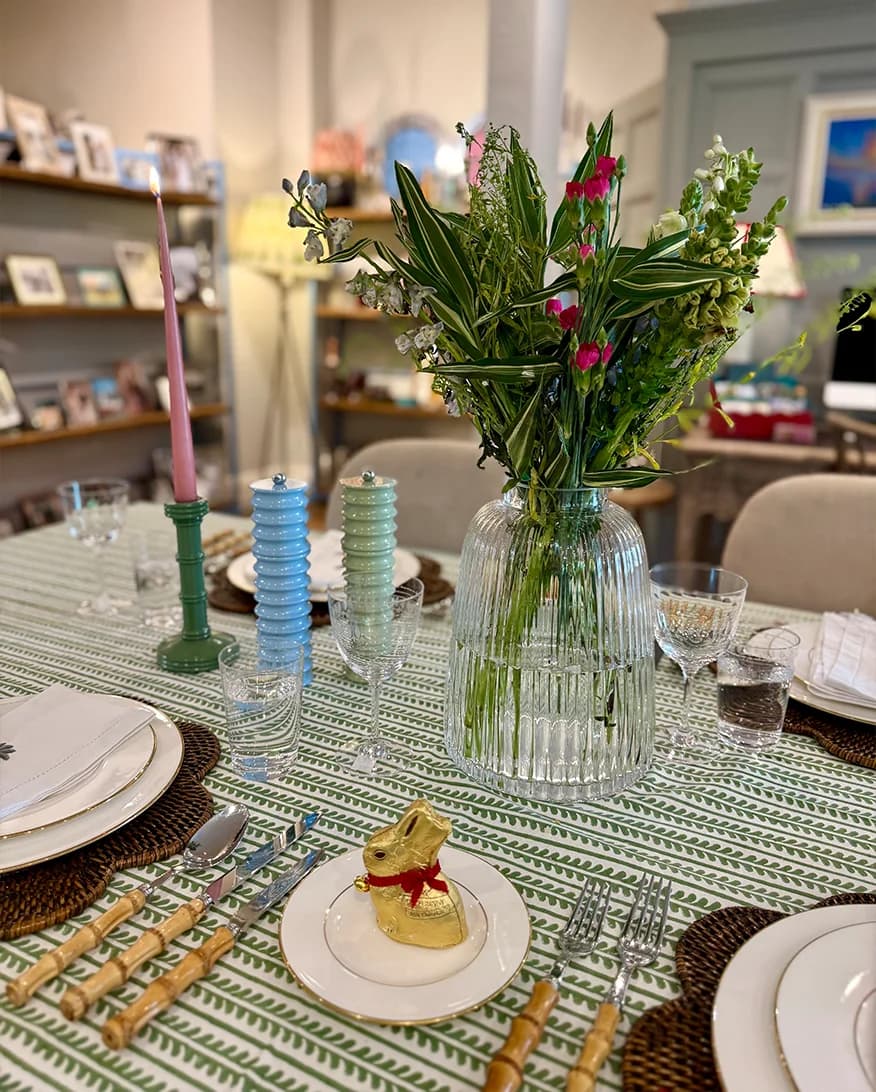 A spring formal setting in The Wedding Present Company showroom, featuring Birdie Fortescue printed tablecloth, The Vintage List glassware, and tableware from OW London and Rebecca Udall