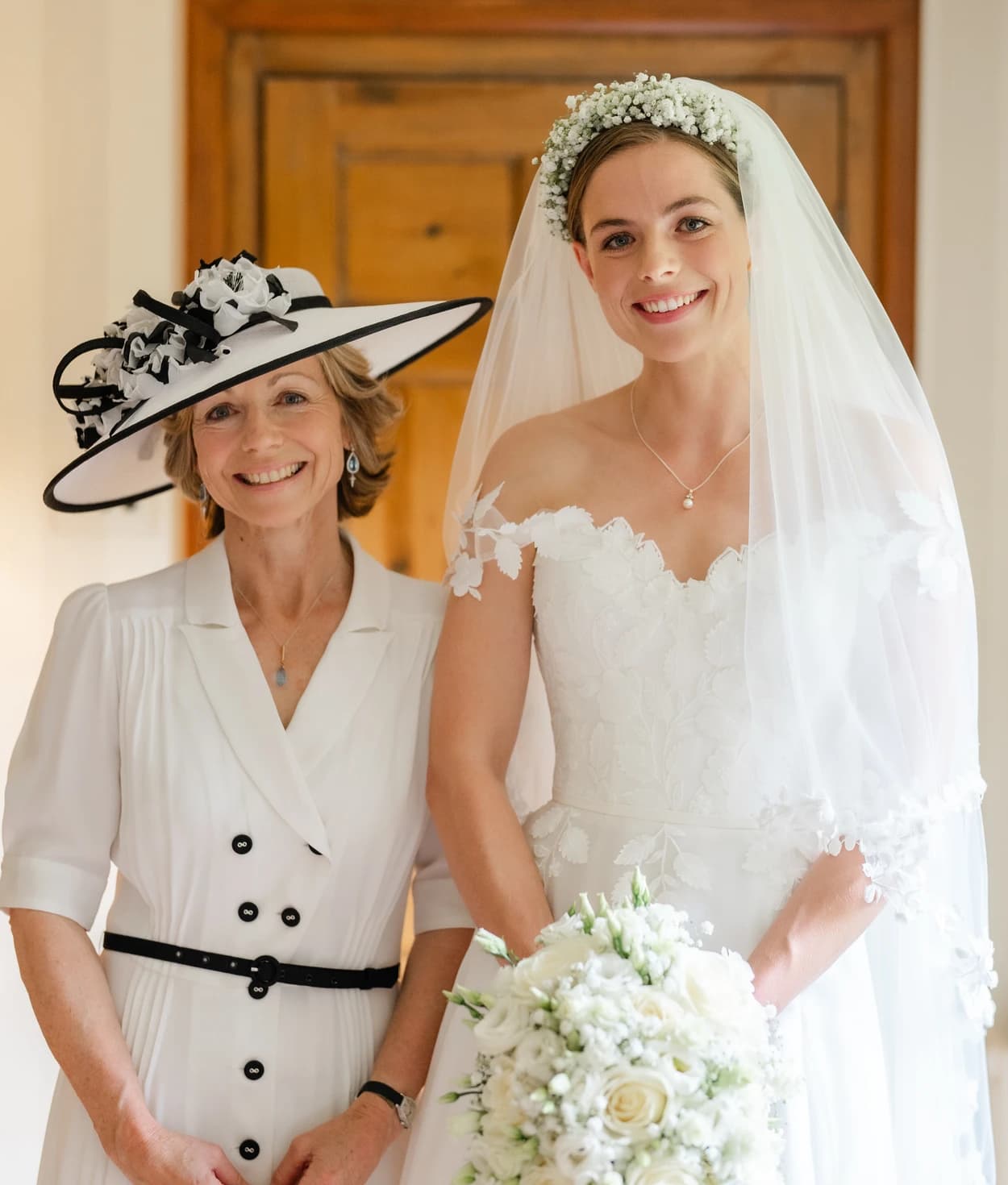 Bride and mother of bride in white outfits