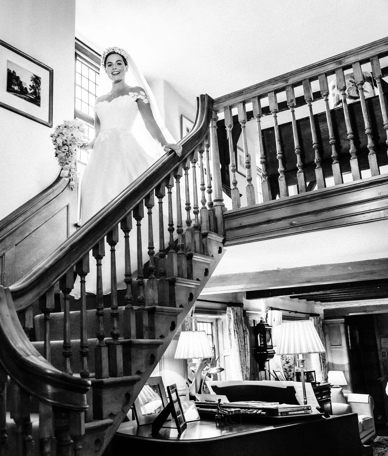 Bride walking down the stairs in her childhood home