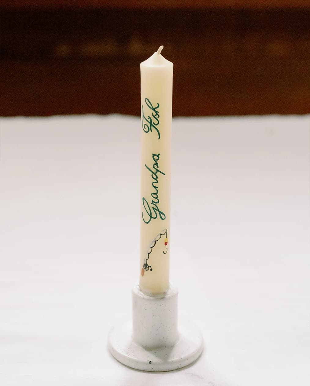 A candle with late grandparent's name