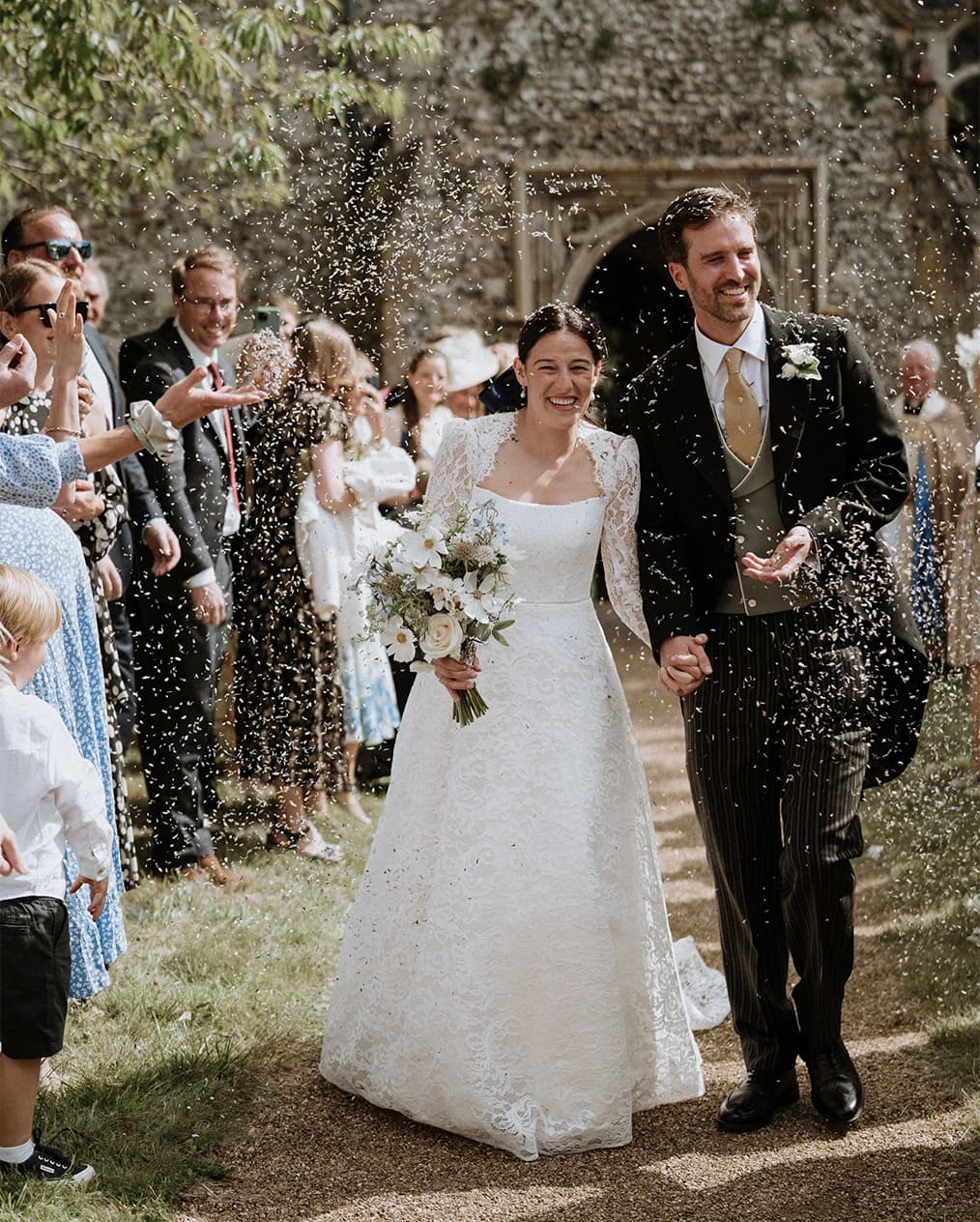 Sophie Breitmeyer and her husband do wedding confetti exit after church ceremony