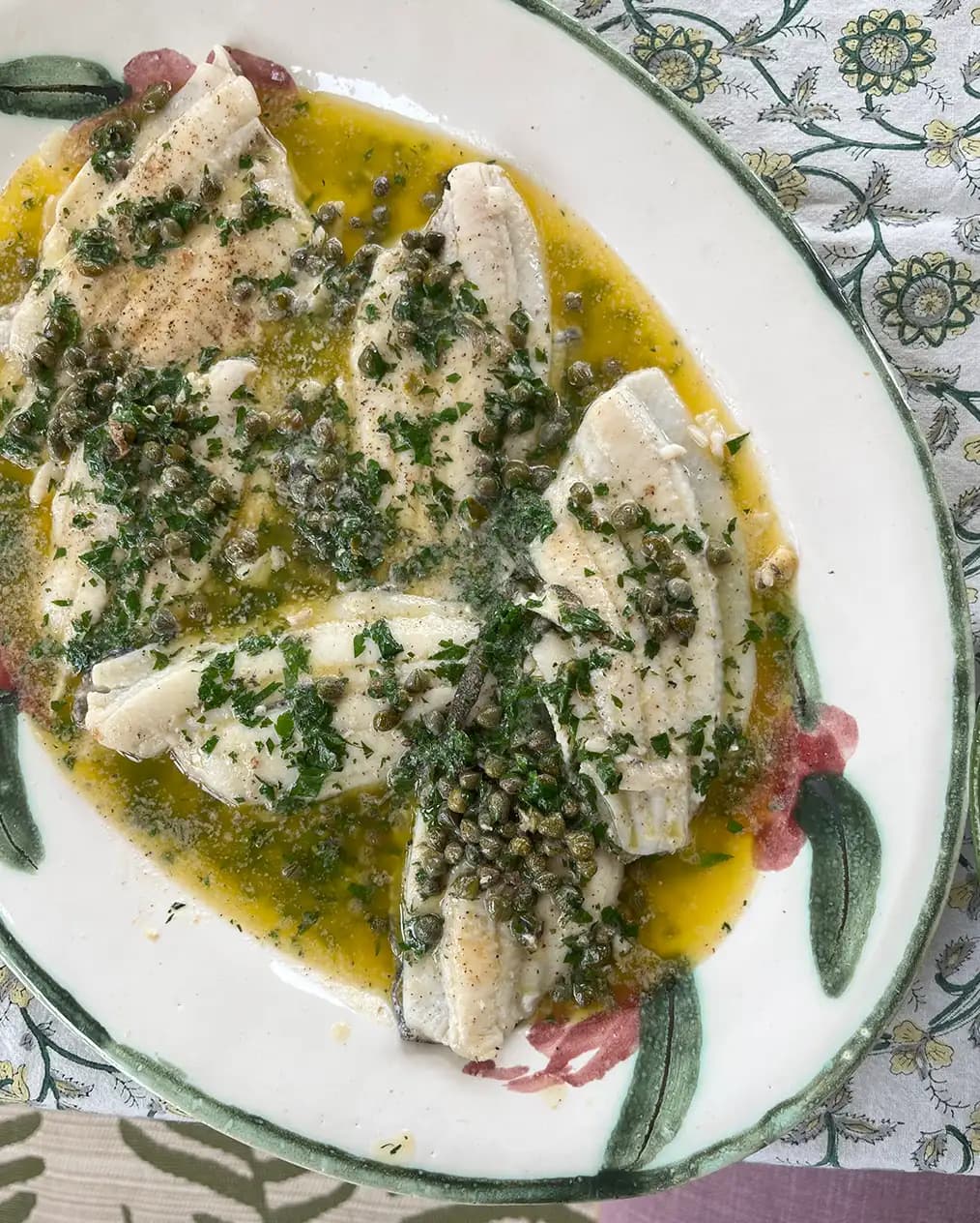Sole fish with peas served on a tableware wedding present, a hand-painted platter.