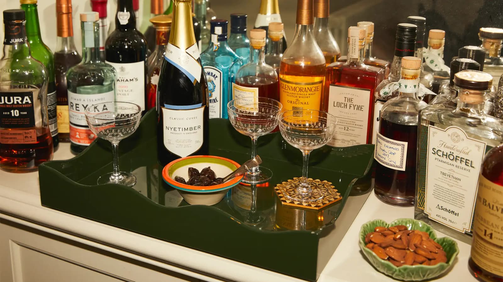 The wedding gifts, champagne coupe glasses and bowls for snacks, are arranged in Rosalyn's home bar.