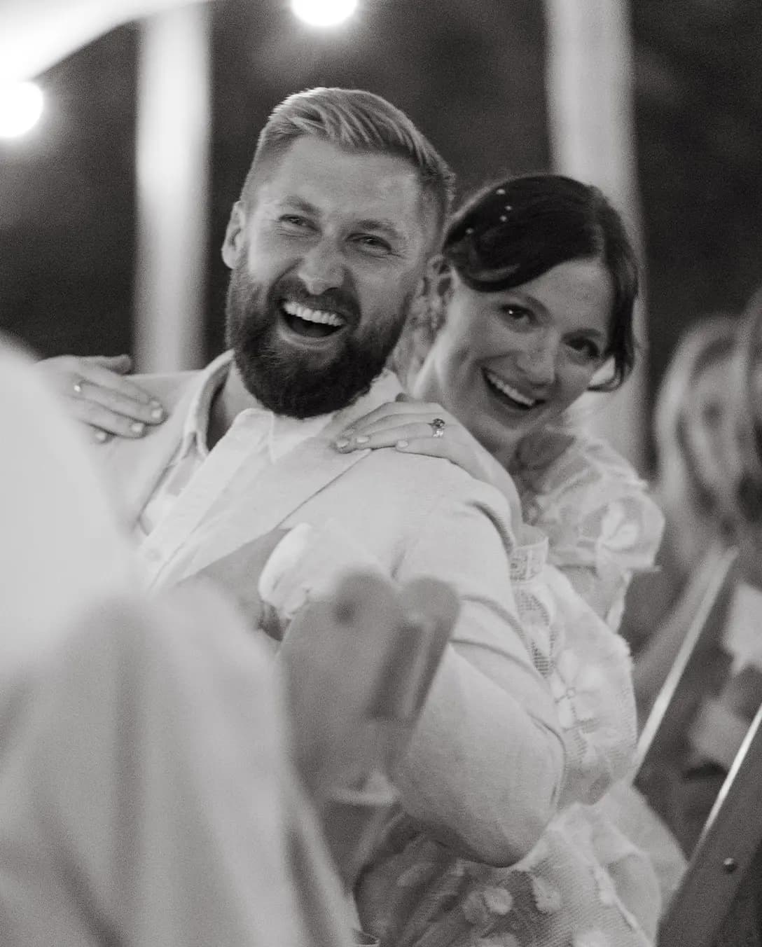 Bride and groom smiling floral garden