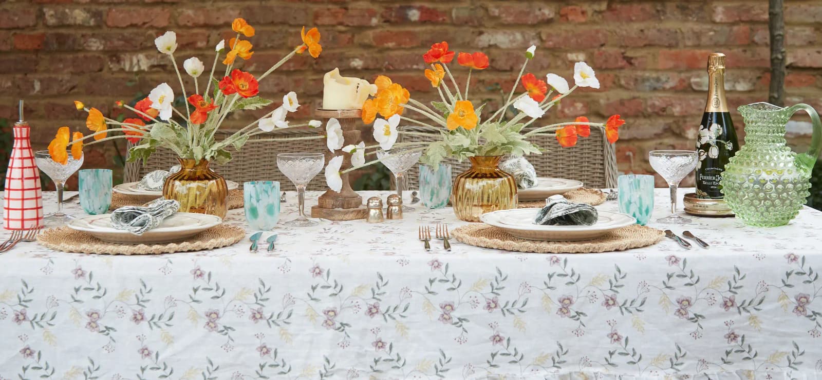 Summer tablescape on floral tablecloth features luxury tableware & glassware wedding presents.