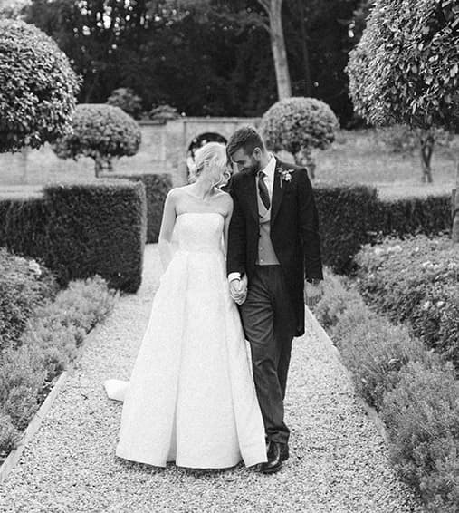 Bride and groom share a tender moment in the garden of their Hampshire country house wedding venue.