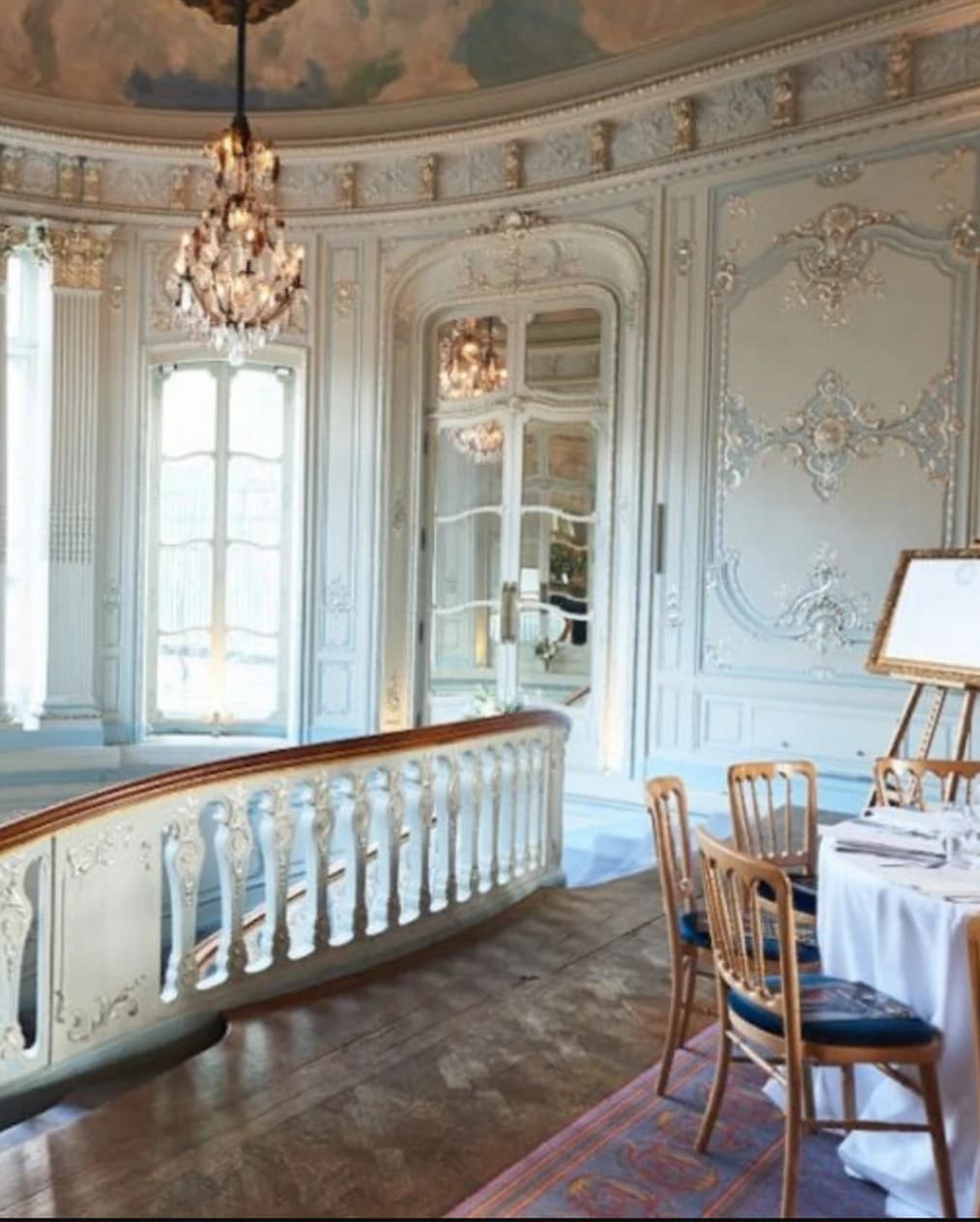 Opulent reception venue with large staircase and chandeliers