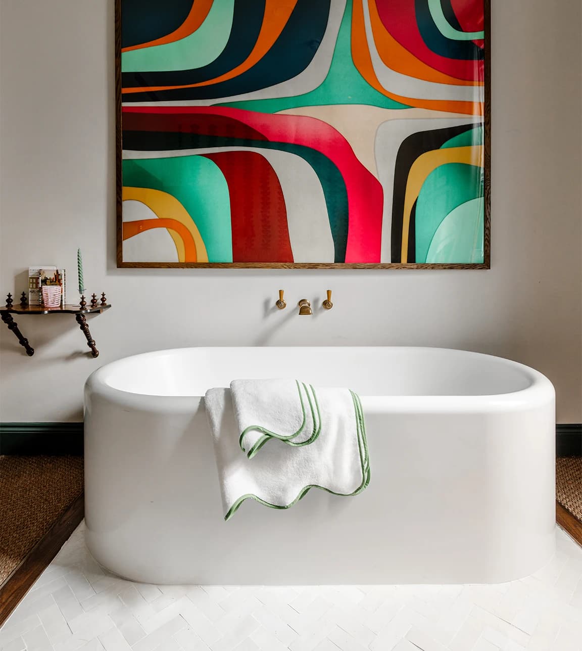 Luxury bathroom with Rebecca Udall scalloped towels placed over bath.