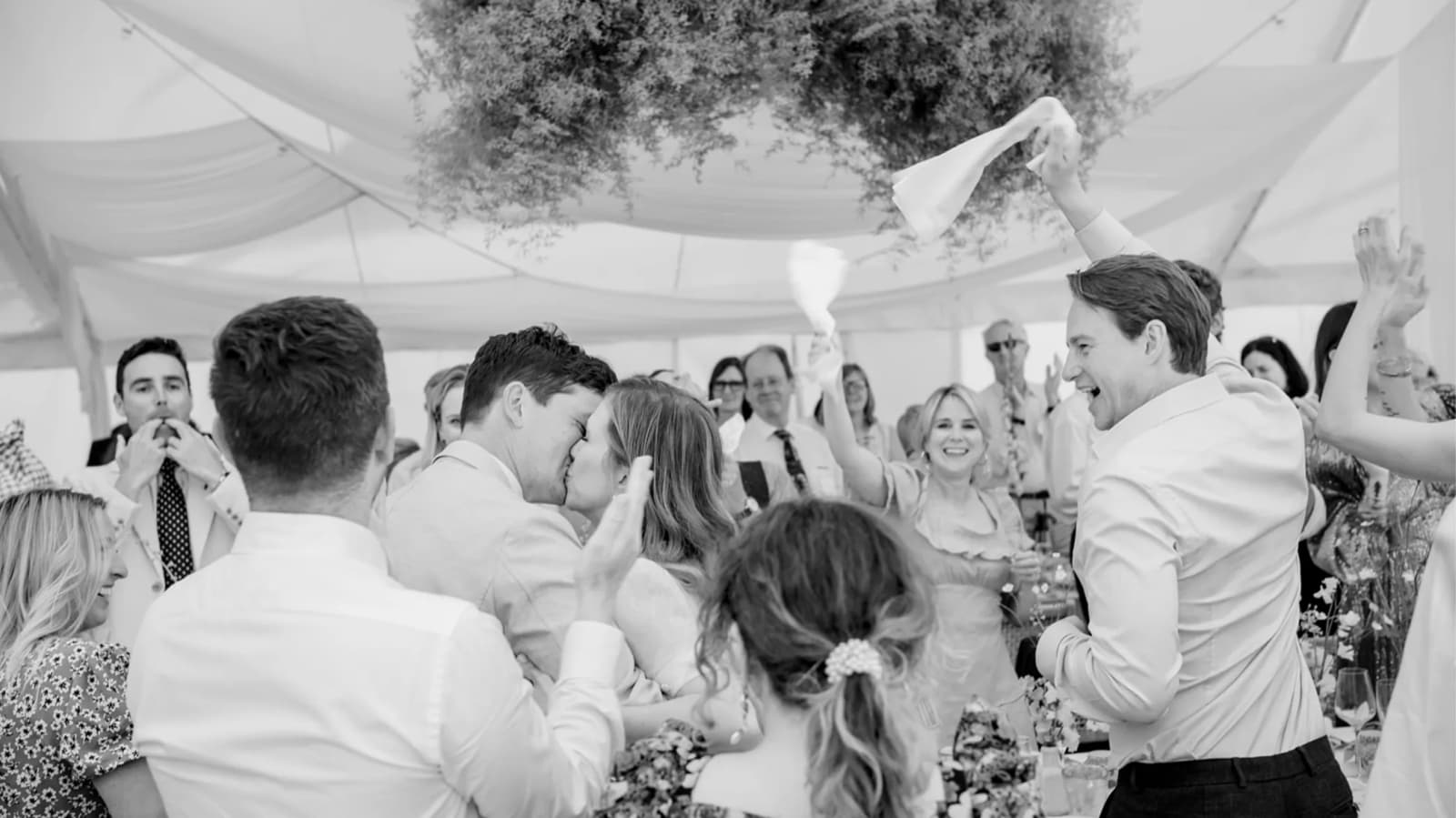 Bride and groom kissing at their wedding party 
