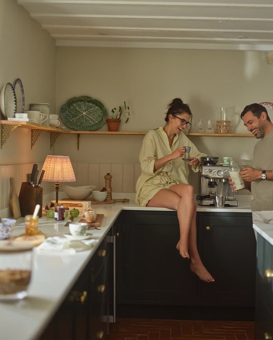 Married couple in the kitchen enjoys coffee using presents from The Wedding Present Company
