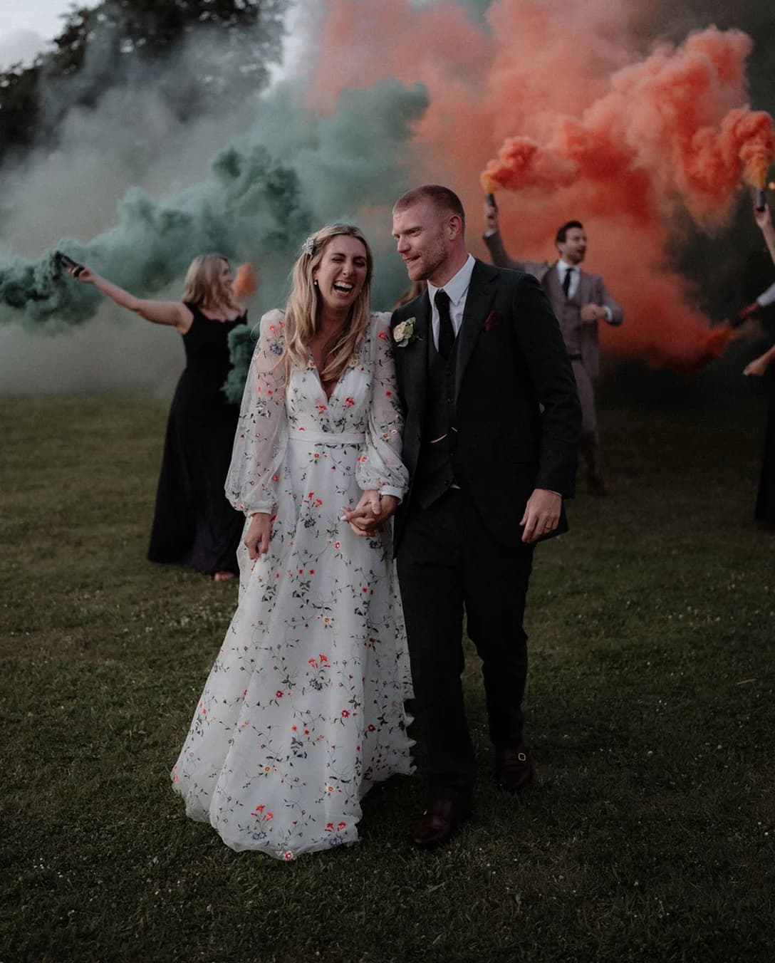Bride and Groom at their Festival Themed Wedding with Colourful Smoke Flares