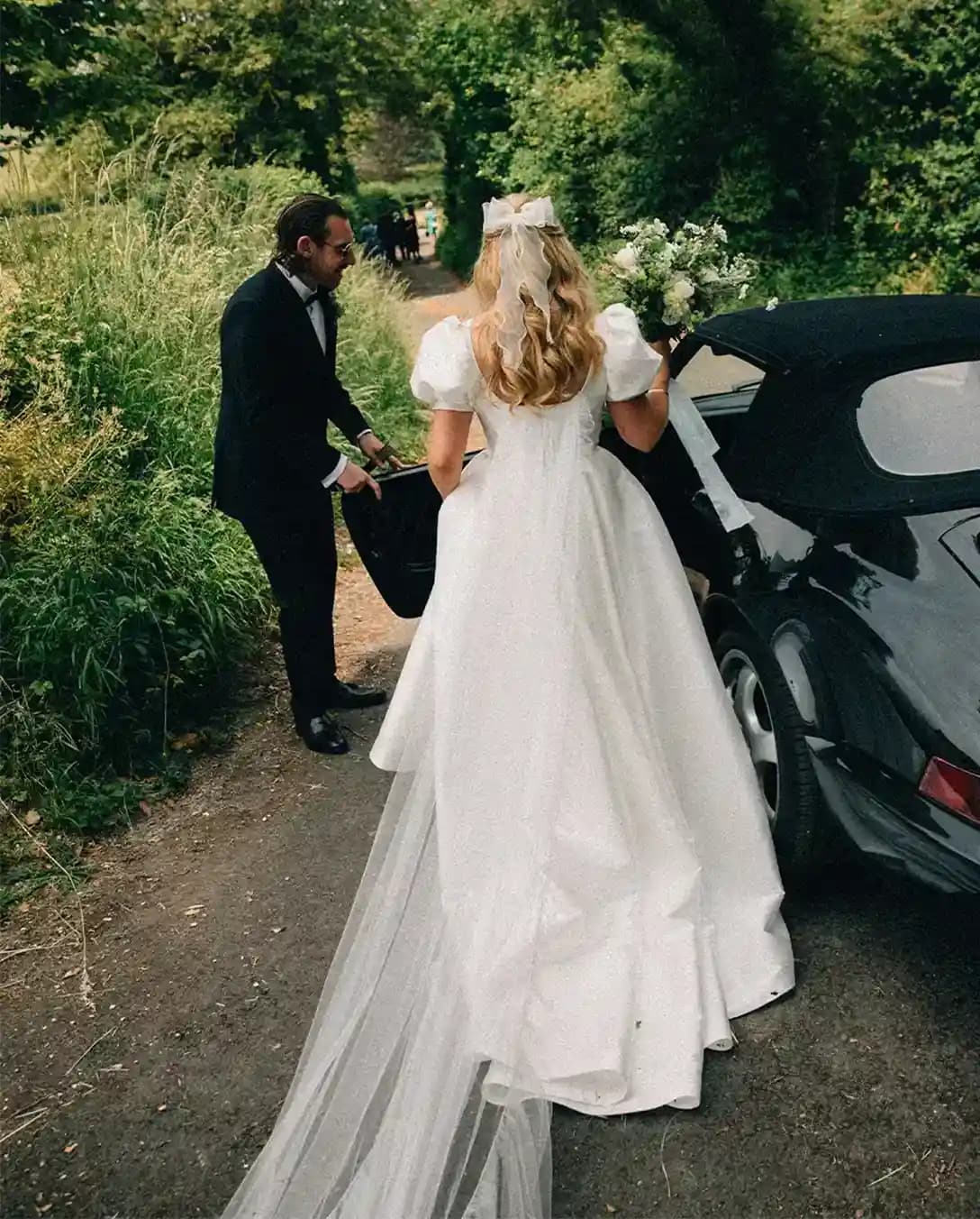 Bride and groom get into vintage car during their whimsical Tuscan Hampshire wedding