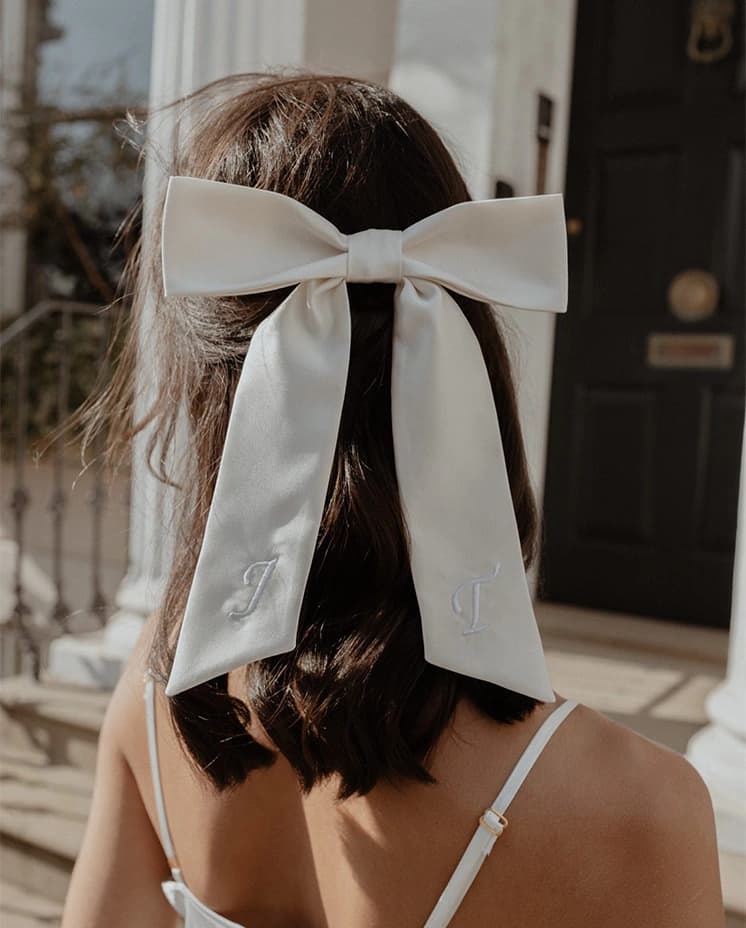 Future brides wear an embroidered hair bow from Gigi and Olive brand.