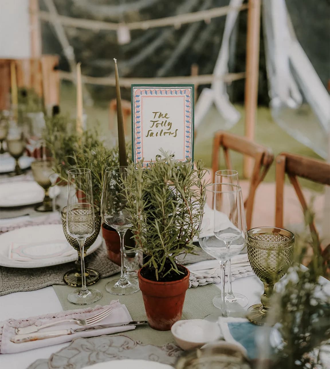 A custom wedding seating sign on a tuscan inspired wedding table with herbs