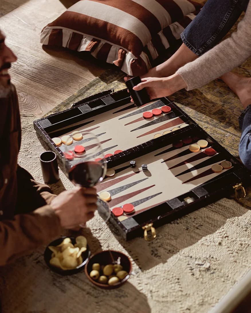 Couple plays backgammon, a luxury homeware present from The Wedding Present Company