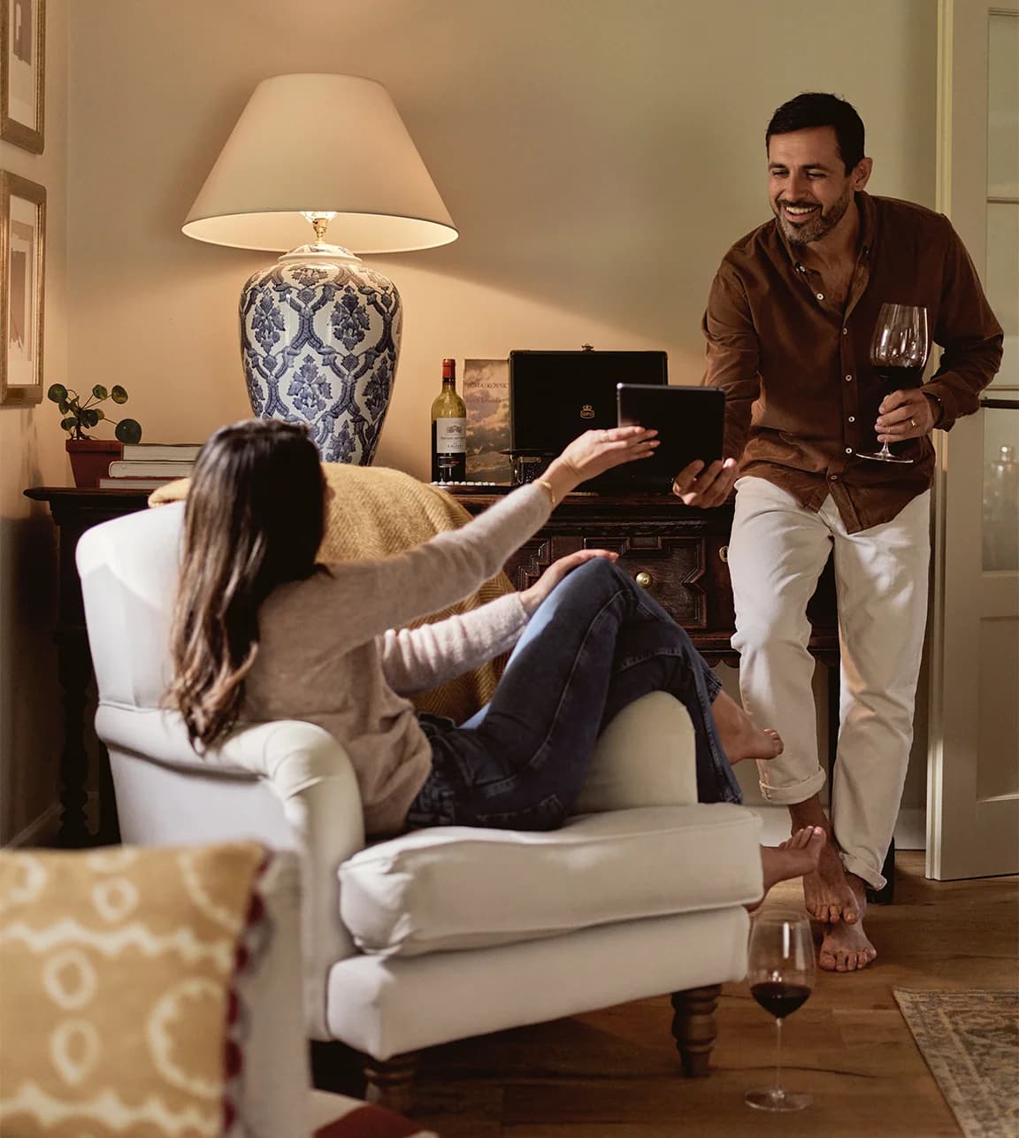 Engaged couple in the living room creates their luxury wedding gift list online on iPad