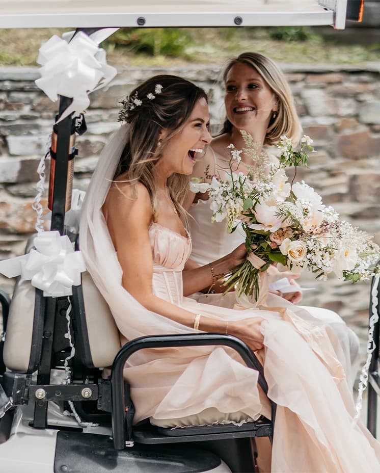 bride and bridesmaid on buggy transport