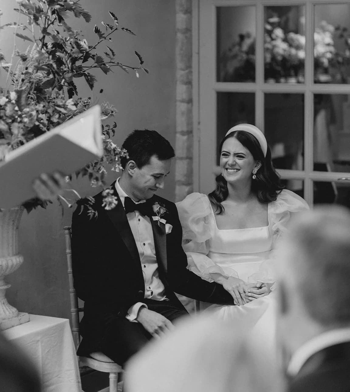 Bride and groom smile during a wedding reading
