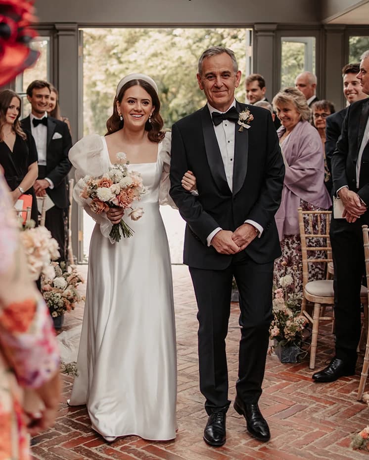 bride and her father walking together 