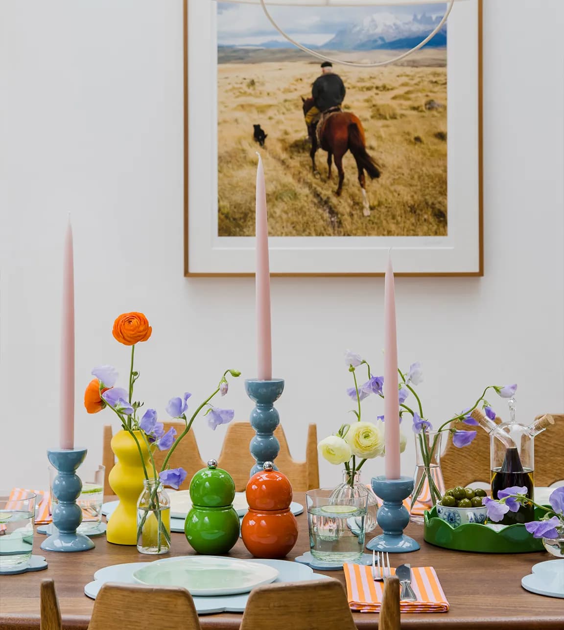 Contemporary dining room with colourful tablesetting that features Addison Ross Bobbin Pepper Mills and Candlesticks