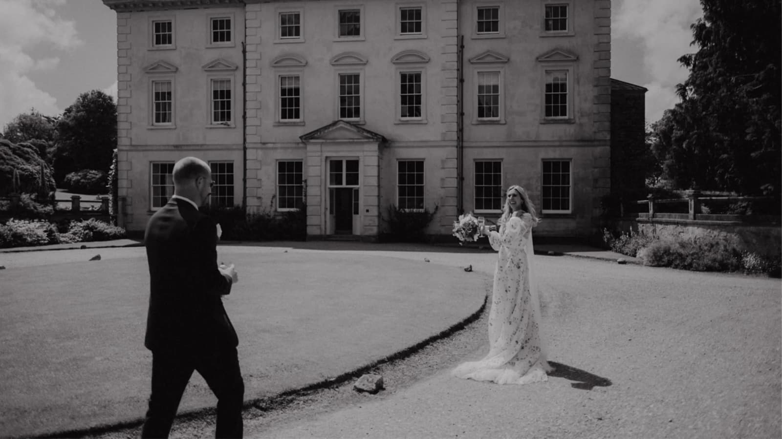 Bride and groom during their first look outside of their Cornish wedding venue at Pencarrow House and Garden