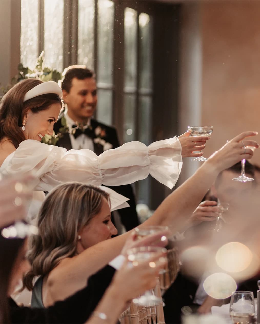 bride and groom cheering the guests drinks