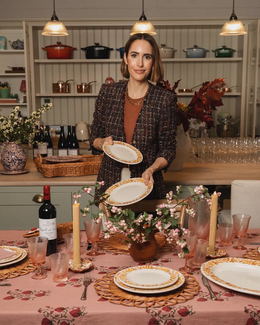Louise Roe, the Founder of Sharland England, holds dinner plates for a tablescape in The Wedding Present Company