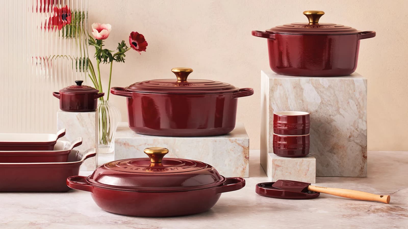 A stack of variety Le Creuset Casseroles in Garnet