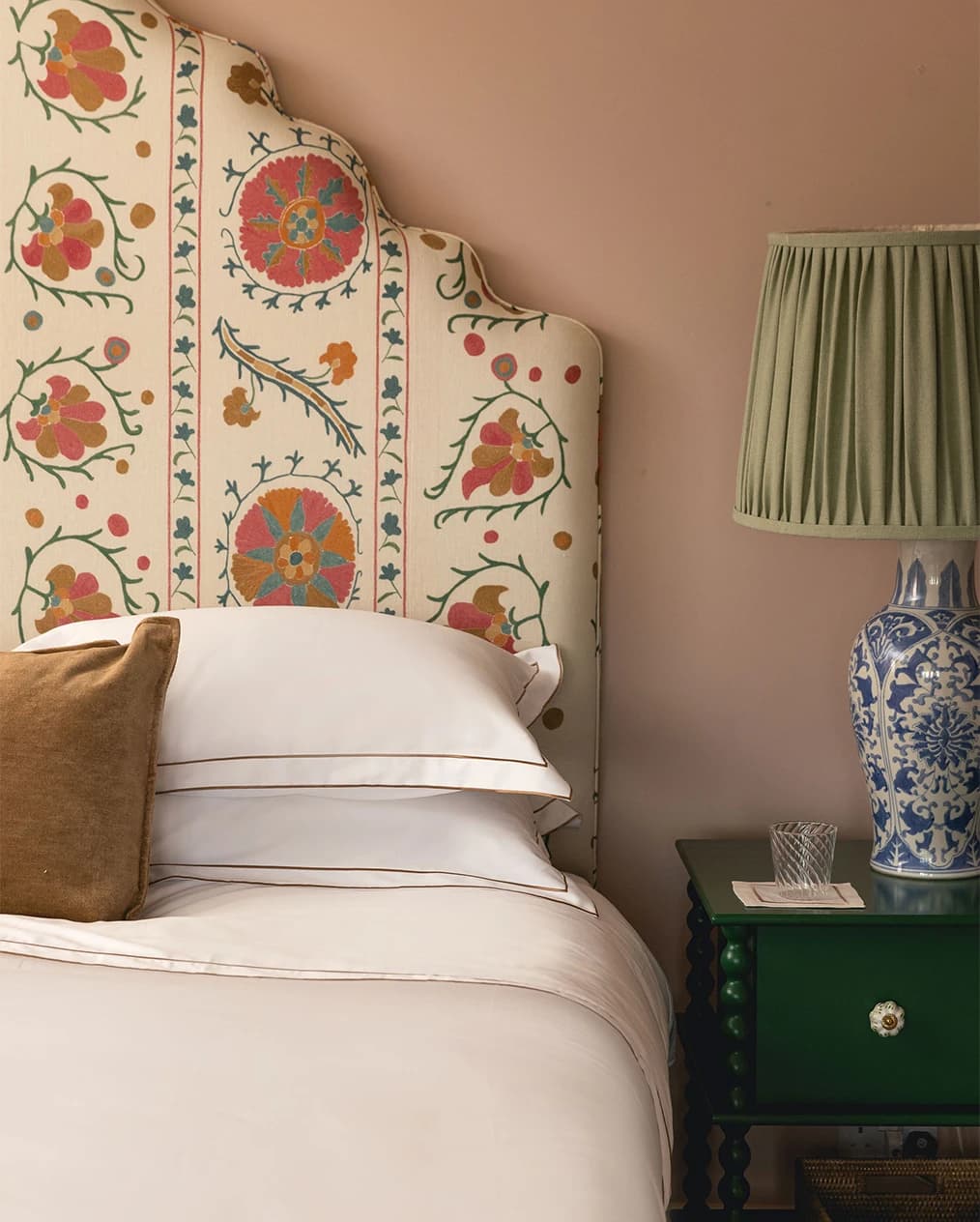 Upholstered bed with sleek Rebecca Udall white bed linen