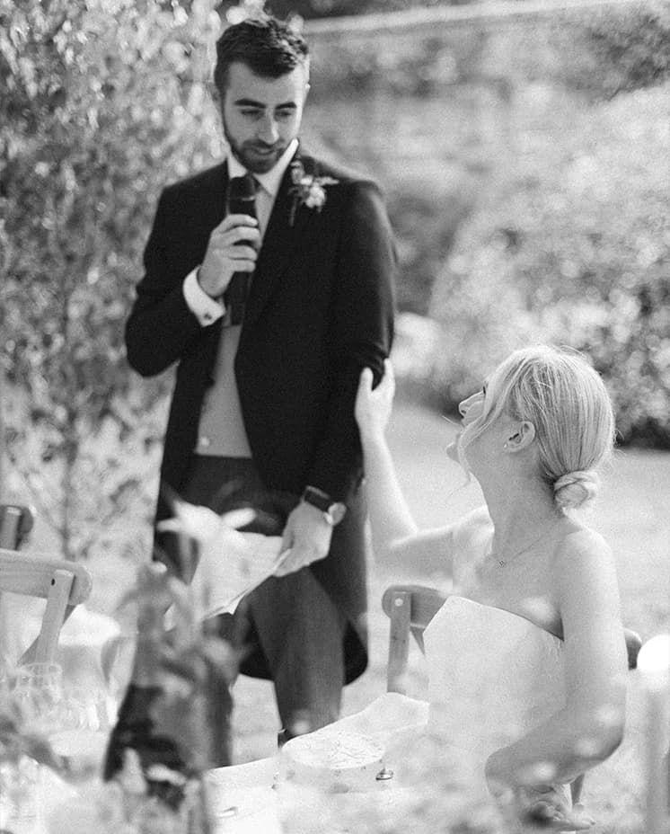 Groom gives a heartfelt speech in front of the bride.