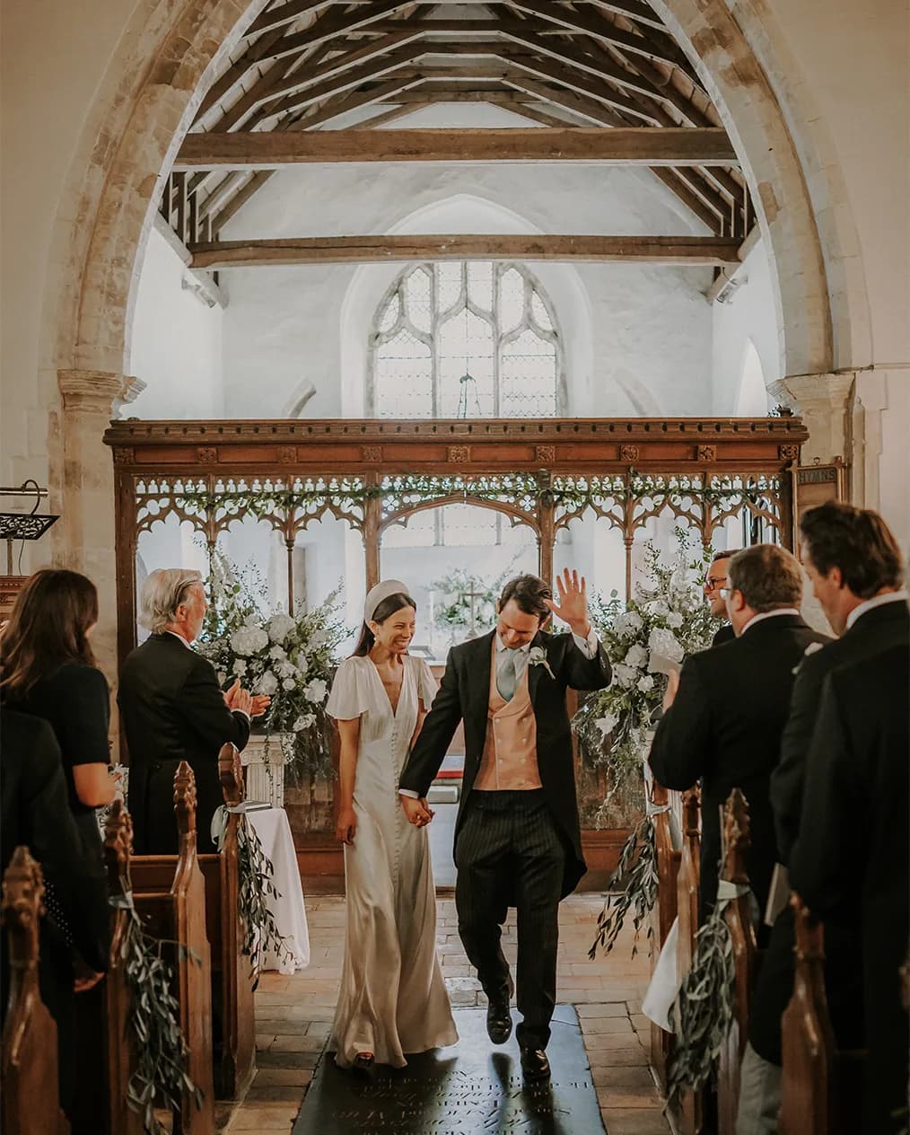 bride and groom walking down the aisle church